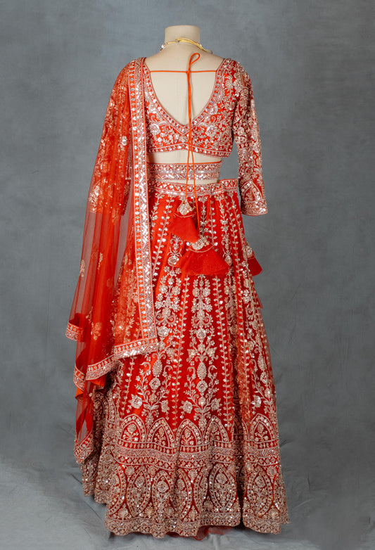 Orange bridal lehenga with embroidered crop top blouse