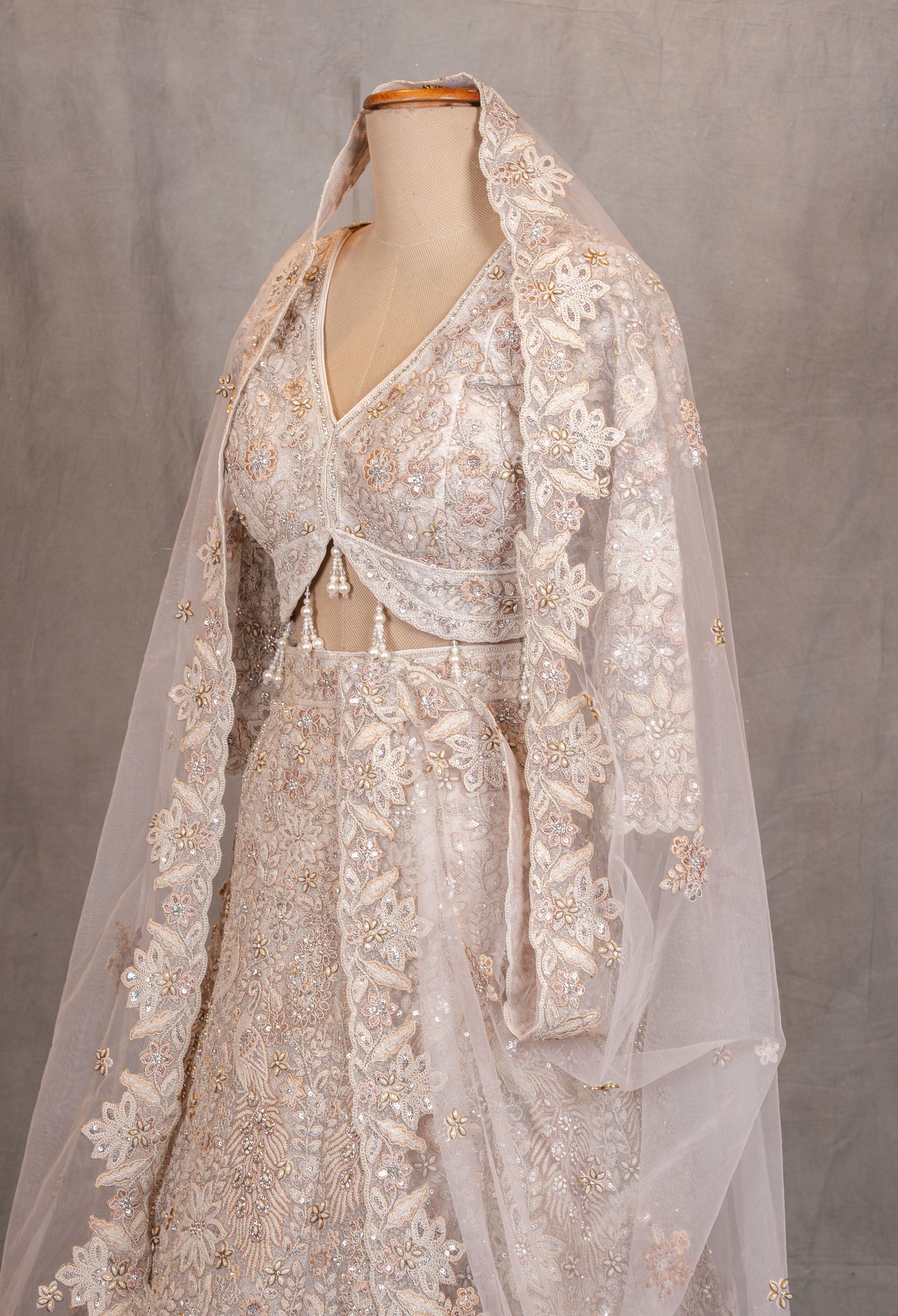 Ivory Heavy Embroidered Bridal Lehenga with V-Neck Blouse & Net Dupatta