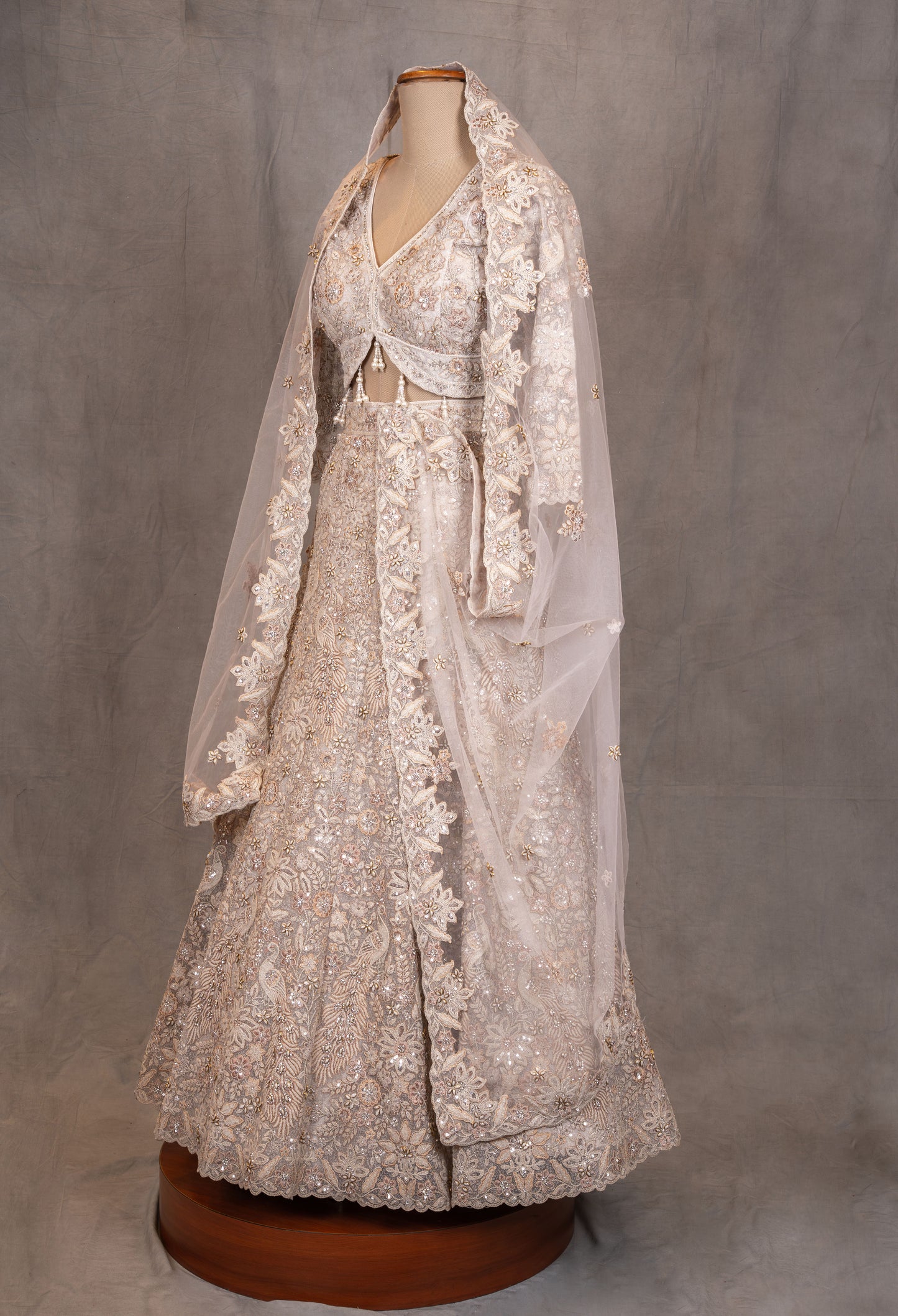 Ivory Heavy Embroidered Bridal Lehenga with V-Neck Blouse & Net Dupatta