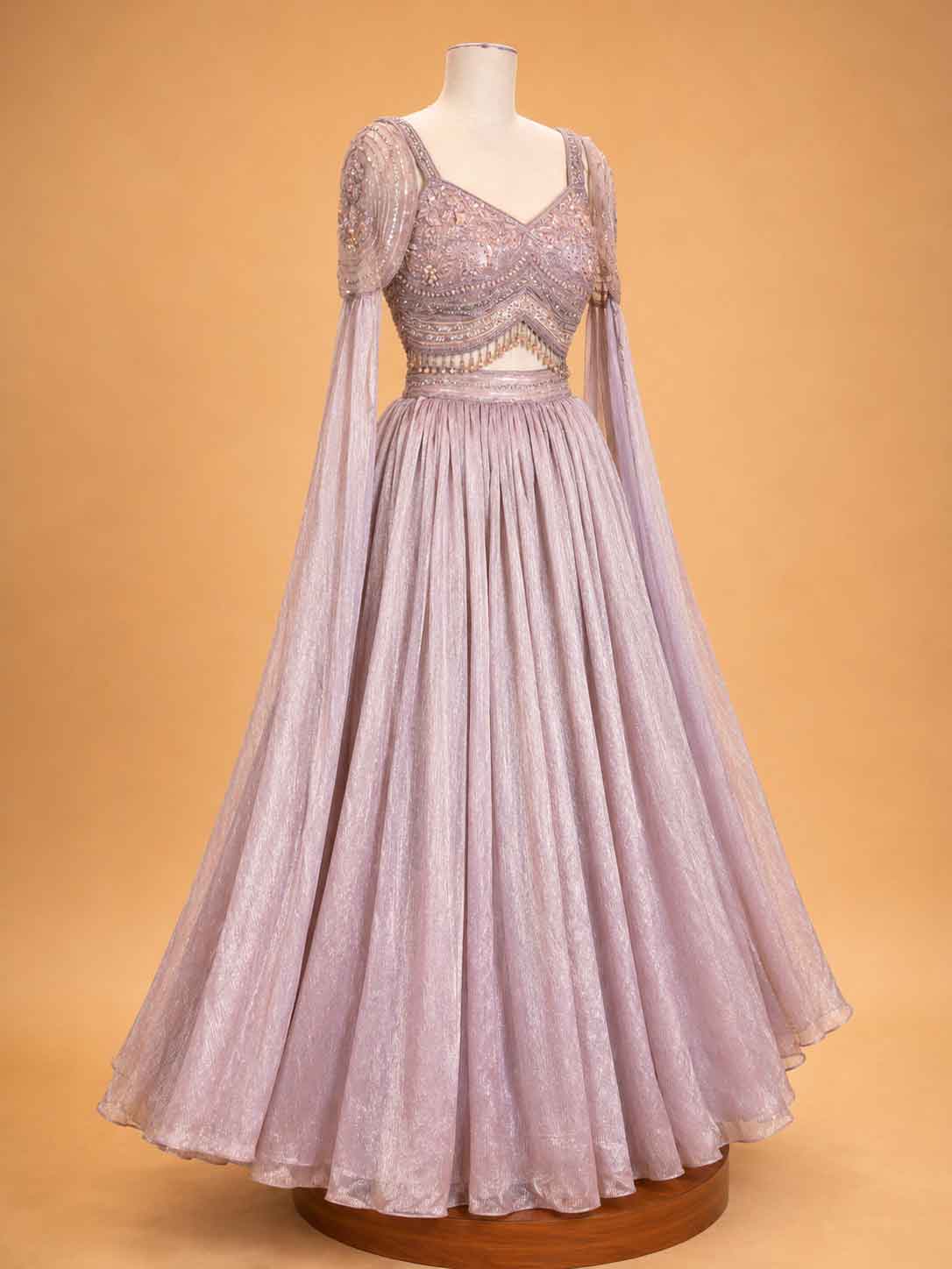 Peach colour embellished designer lehenga set for women with flared skirt and sheer sleeves