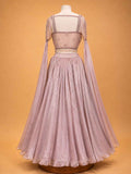 Peach colour embellished designer lehenga set for women with flared skirt and sheer sleeves