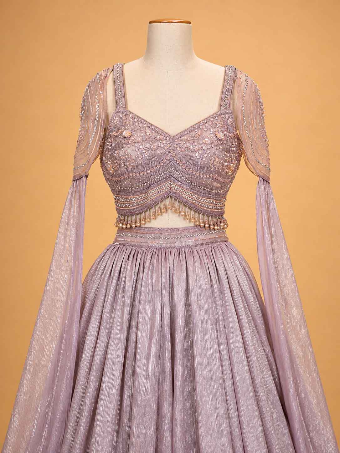 Peach colour embellished designer lehenga set for women with flared skirt and sheer sleeves