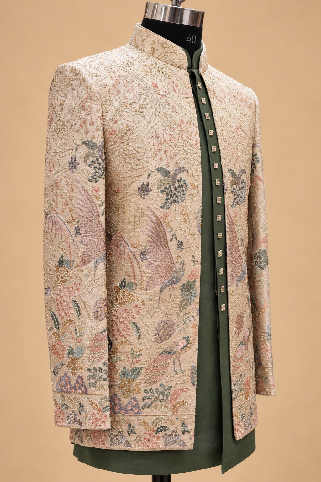 Olive green kurta layered under beige floral sherwani jacket