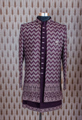 Elegant plum purple sherwani with all-over embroidery and brooch, paired with tailored trousers. Perfect for weddings, receptions, and festive wear.