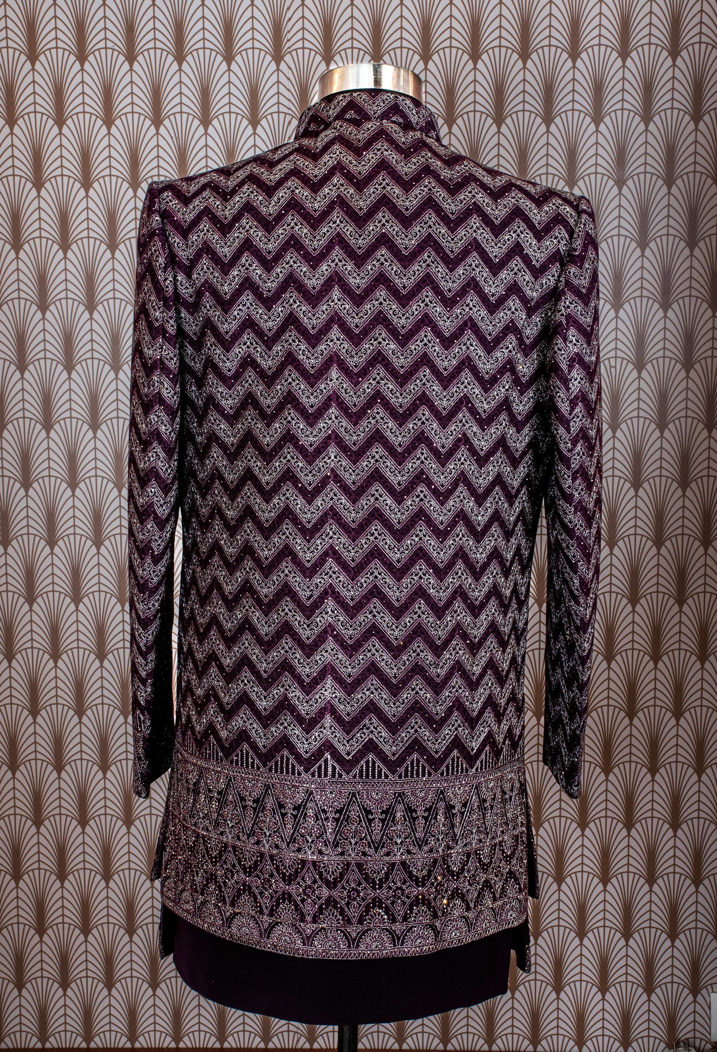 Elegant plum purple sherwani with all-over embroidery and brooch, paired with tailored trousers. Perfect for weddings, receptions, and festive wear.