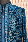 Royal blue velvet sherwani with intricate embroidery, satin kurta, and trousers. Perfect for weddings, receptions, and festive occasions.
