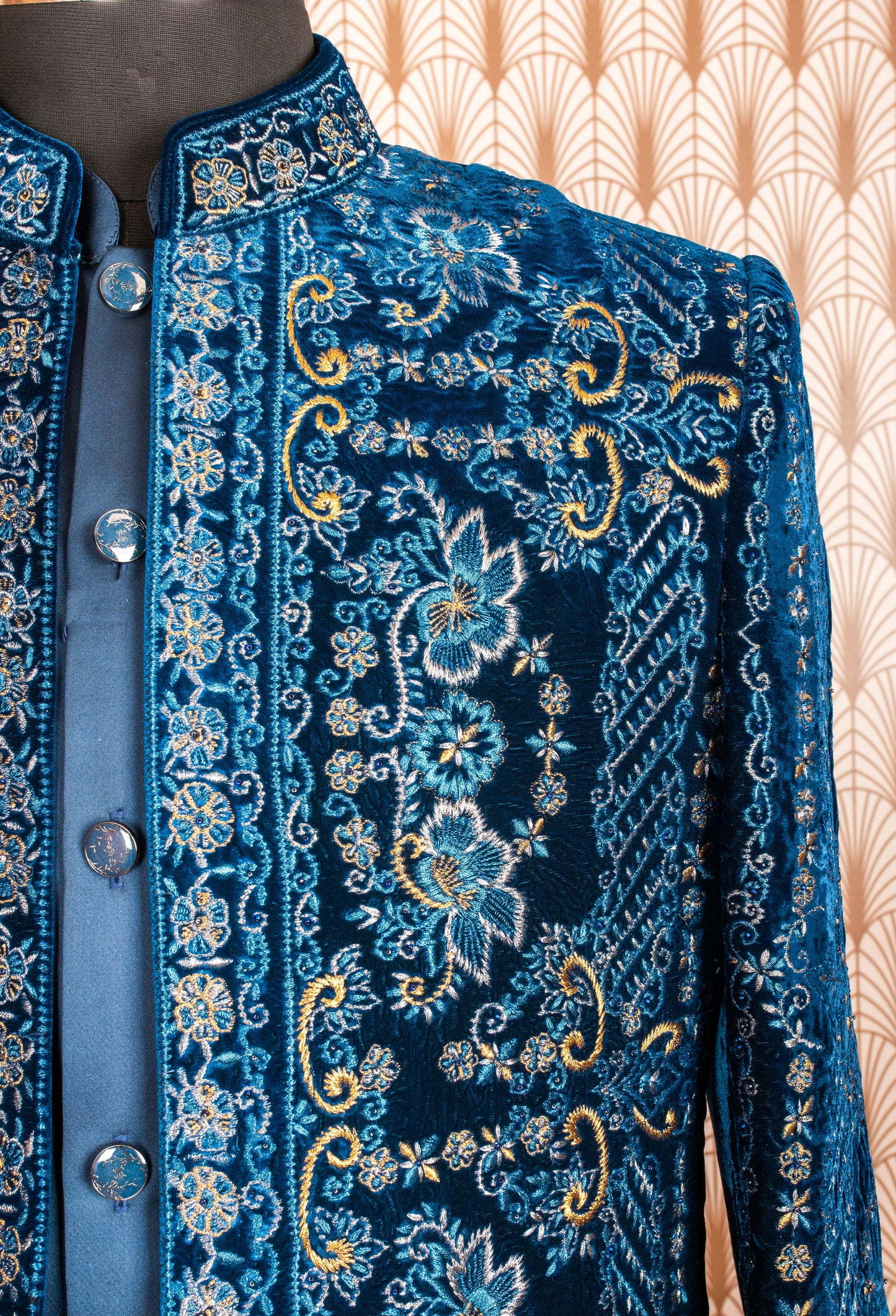 Royal blue velvet sherwani with intricate embroidery, satin kurta, and trousers. Perfect for weddings, receptions, and festive occasions.