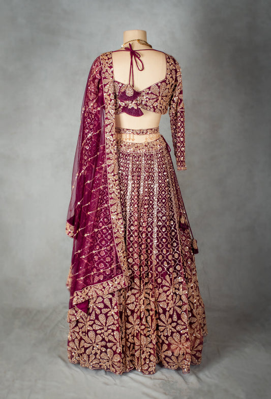 Maroon velvet bridal lehenga with embroidered net dupatta