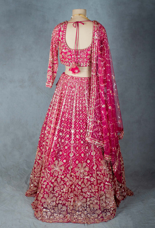 Hot pink lehenga with V-neck embroidered blouse
