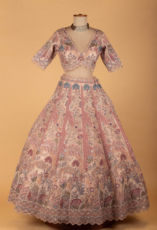 Blush pink bridal lehenga with floral embroidery and sequins